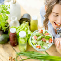 woman-eating-healthy-salad-young-microbiome-diet-dt-FEATURE