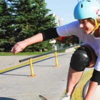 picture of a person skateboarding in a park wearing protective gear