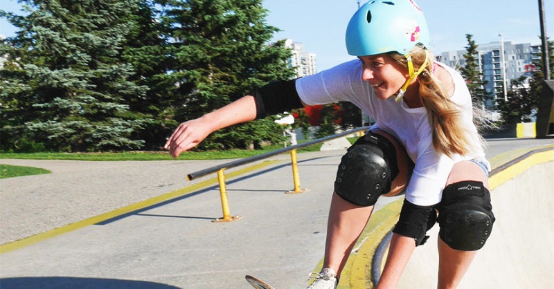 picture of a person skateboarding in a park wearing protective gear