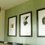 3 large phot frames on a olive green wall