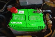 Close-up view of an installed Amaron car battery, highlighting its green casing and robust build, ensuring long-lasting power and reliability.