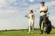 man and woman dressed for golf