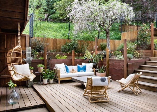 patio with beautiful greenery and furniture sets